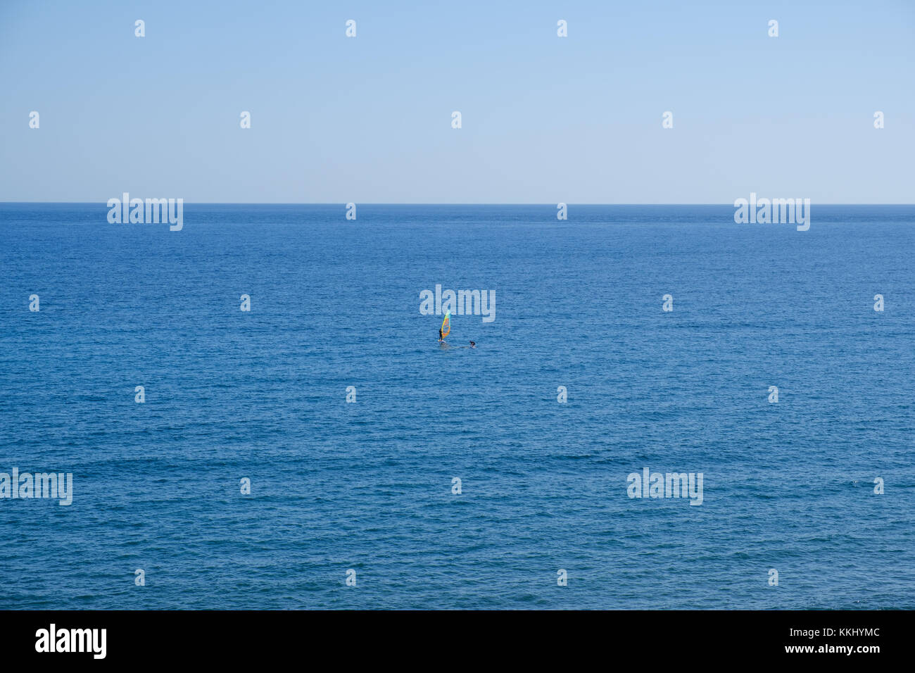 windsurfer far away - ocean horizon with blue sky Stock Photo