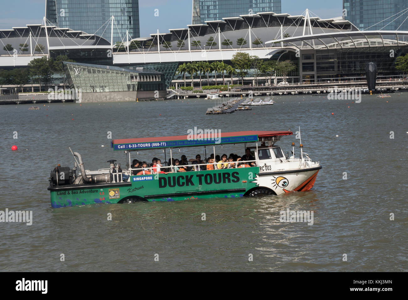 Marina Bay in Singapore at the mouth of the Singapore River with a Duck tourist boat in the foreground Stock Photo
