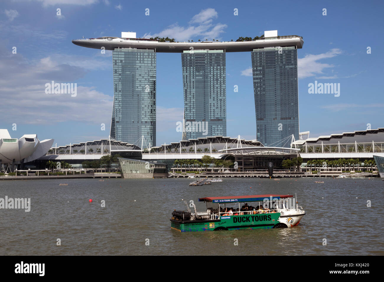Marina Bay Sands Hotel in Singapore at the mouth of the Singapore River with a Duck tourist boat in the foreground Stock Photo