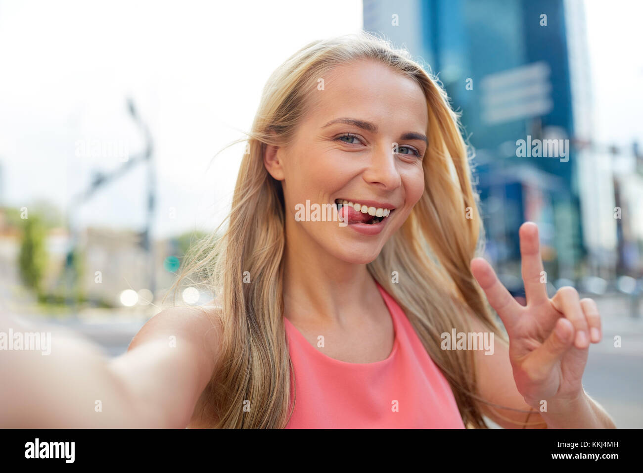 happy young woman taking selfie on city street Stock Photo - Alamy