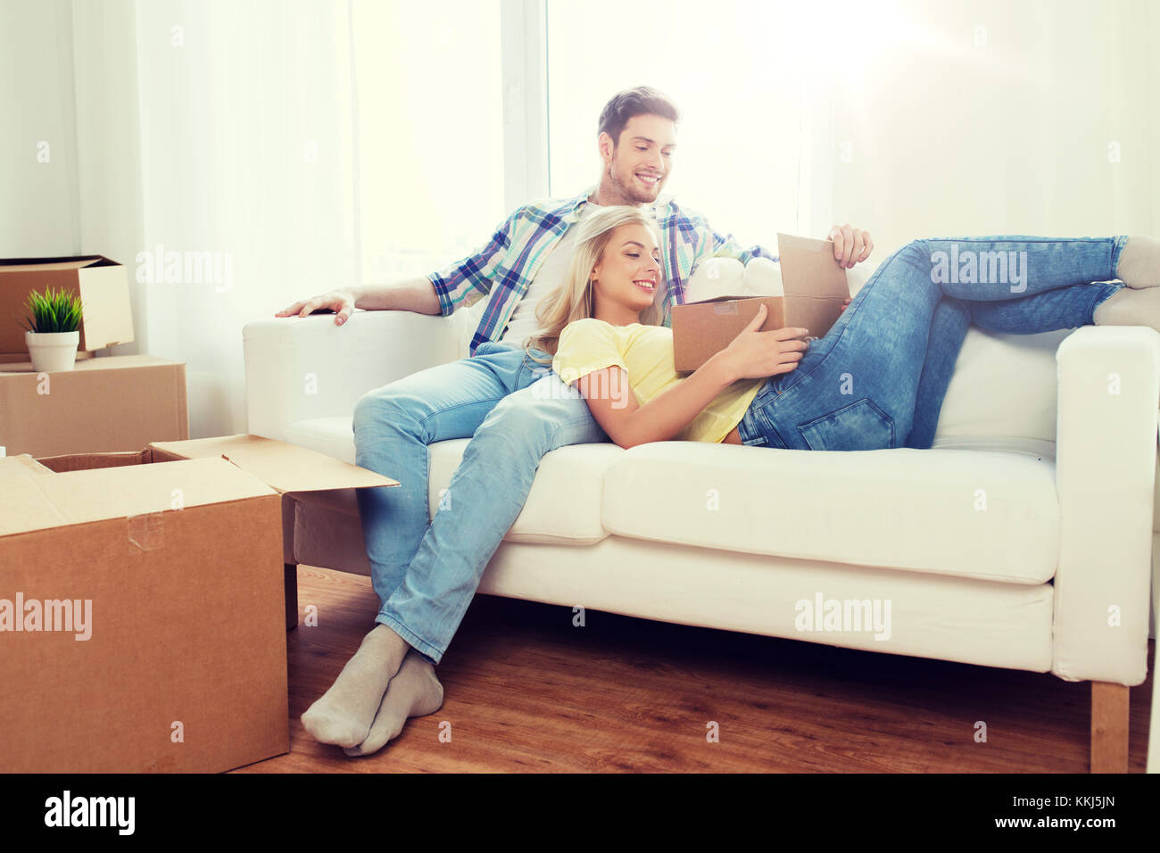 happy couple with big cardboard boxes at new home Stock Photo - Alamy