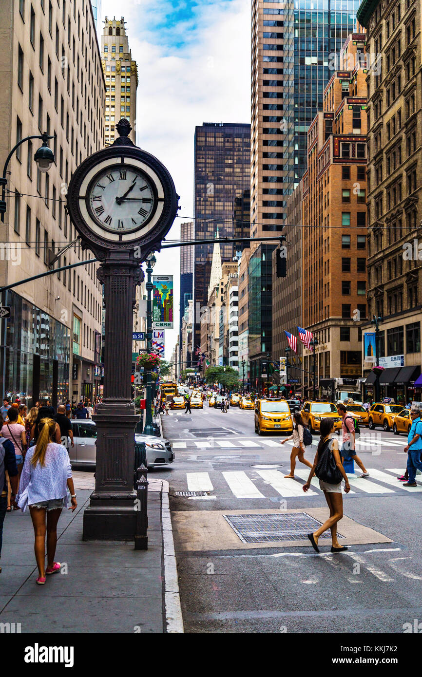 Busy stret and sidewalk clock at 5th Avenue in Manhattan,  New York City, USA Stock Photo