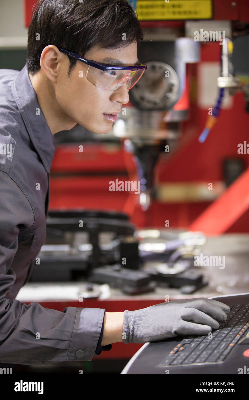 Confident Chinese engineer working in the factory Stock Photo Alamy