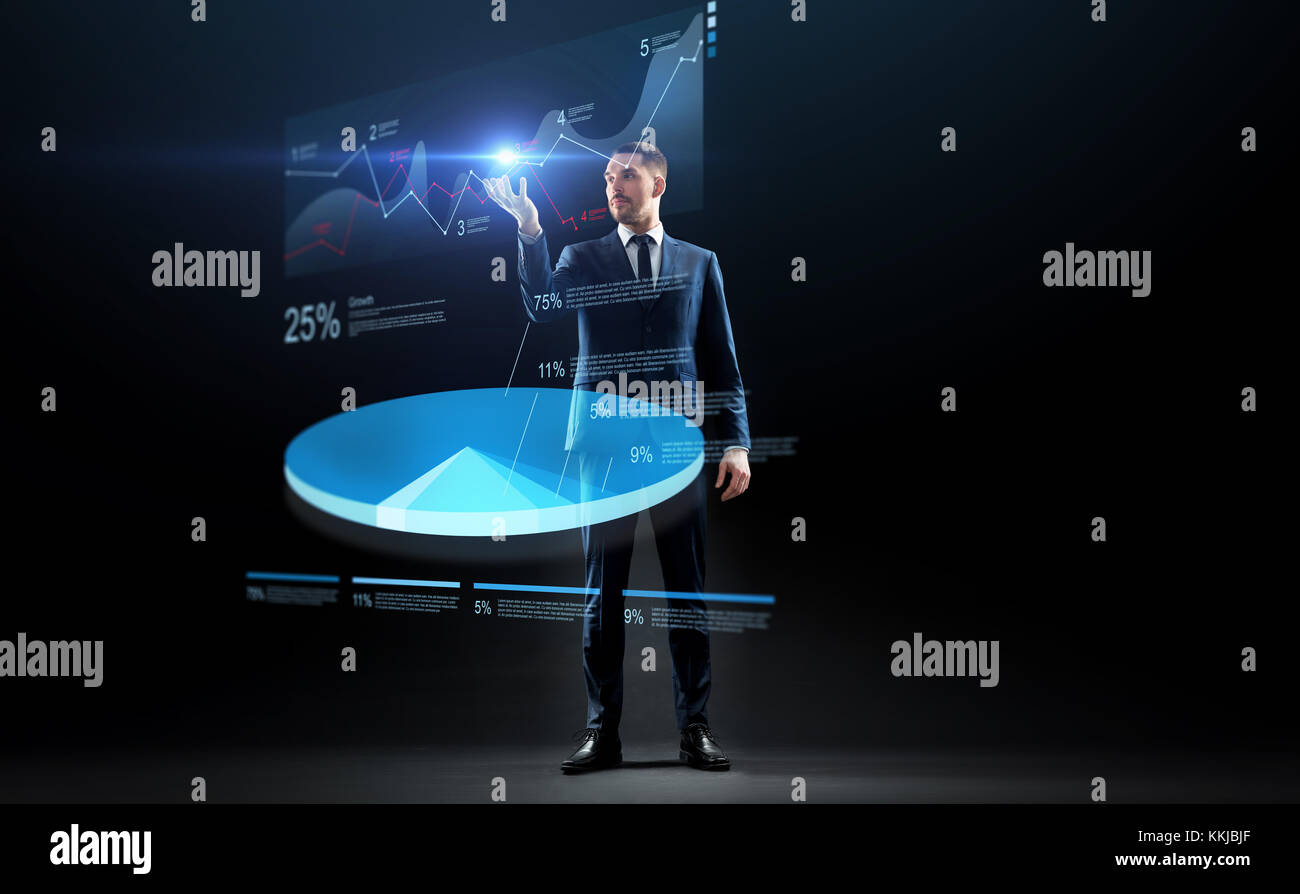 businessman in suit working with virtual pie chart Stock Photo