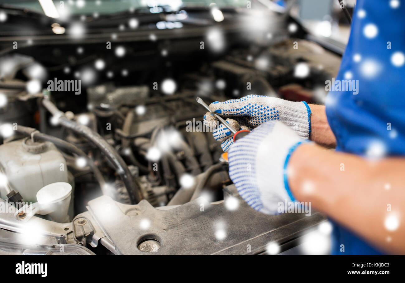 mechanic hands with wrench repairing car Stock Photo