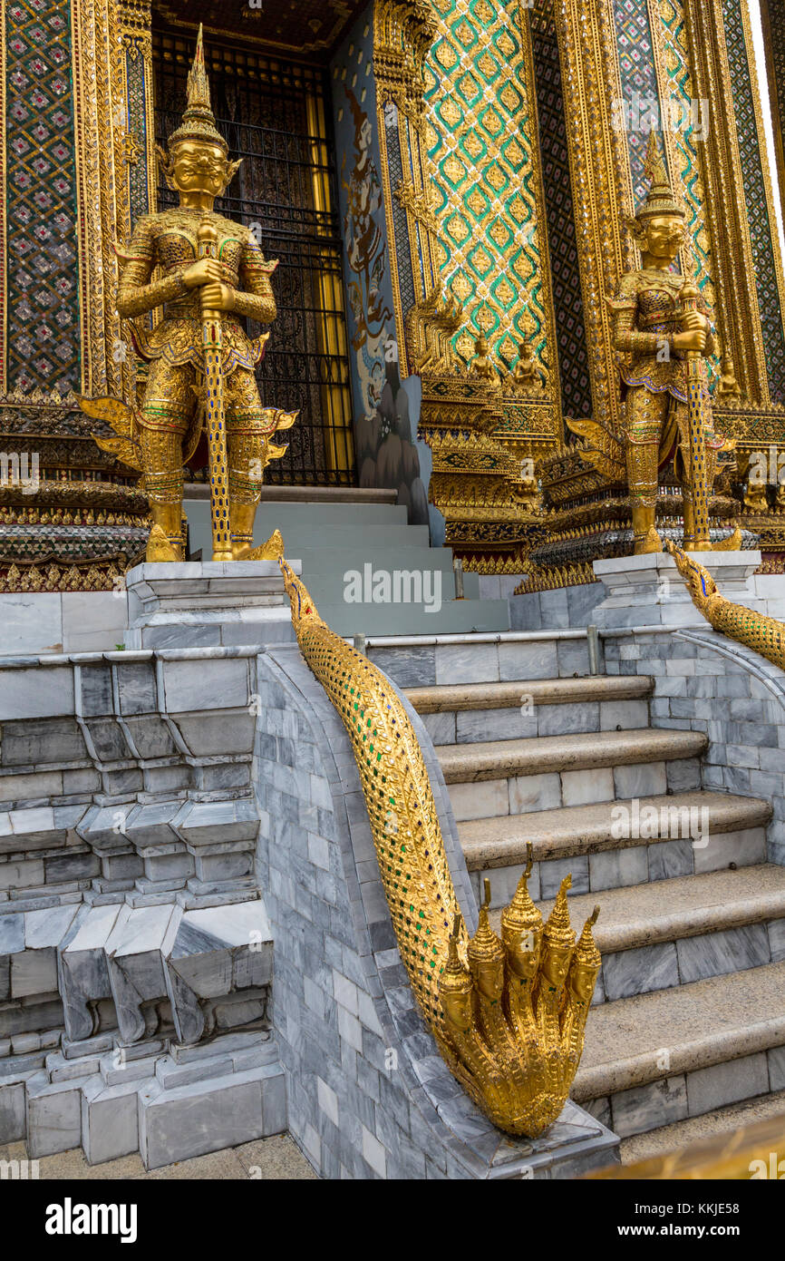 Bangkok, Thailand.  Demons (Yakshas)  and Five-headed Naga (Snake) Guarding Entrance to the Phra Mondop, Royal Grand Palace Compound. Stock Photo