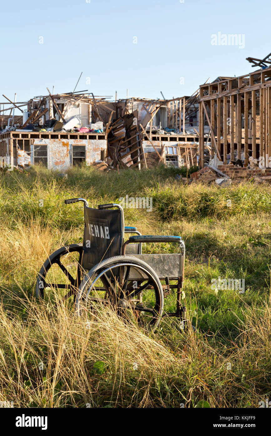 Abandoned wheelchair, setting in common area, destroyed two story apartment units, hurricane 'Harvey' 2017. Stock Photo