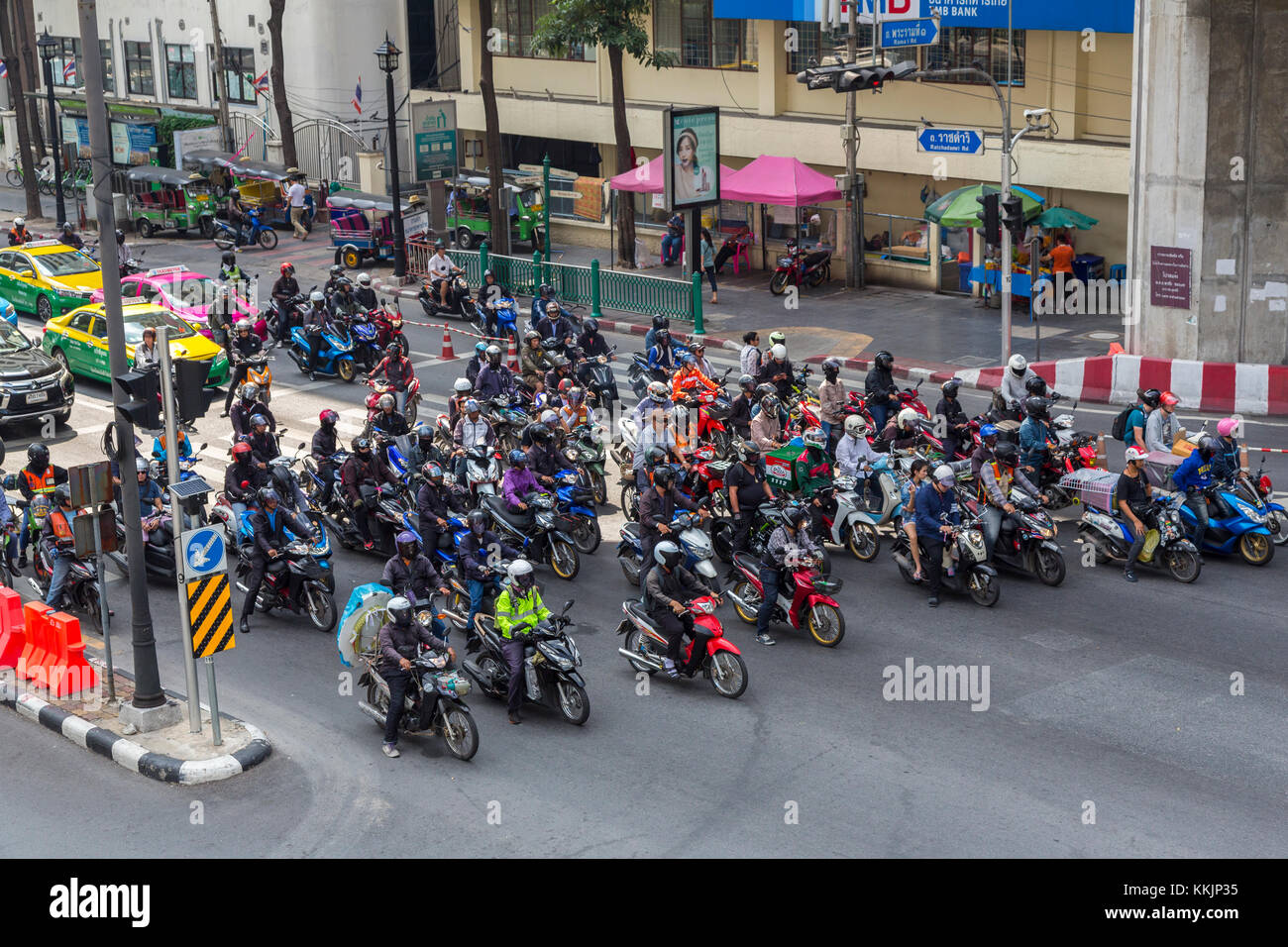 Bangkok, Thailand.  Motorcycles at Intersection by the Erawan Shrine. Stock Photo