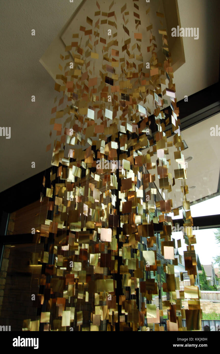Wind and Water Chime is an outdoor decorative piece that uses wind to create sound, typically made from metal or bamboo. It is a common feature in gardens, providing a peaceful, natural ambiance. Stock Photo