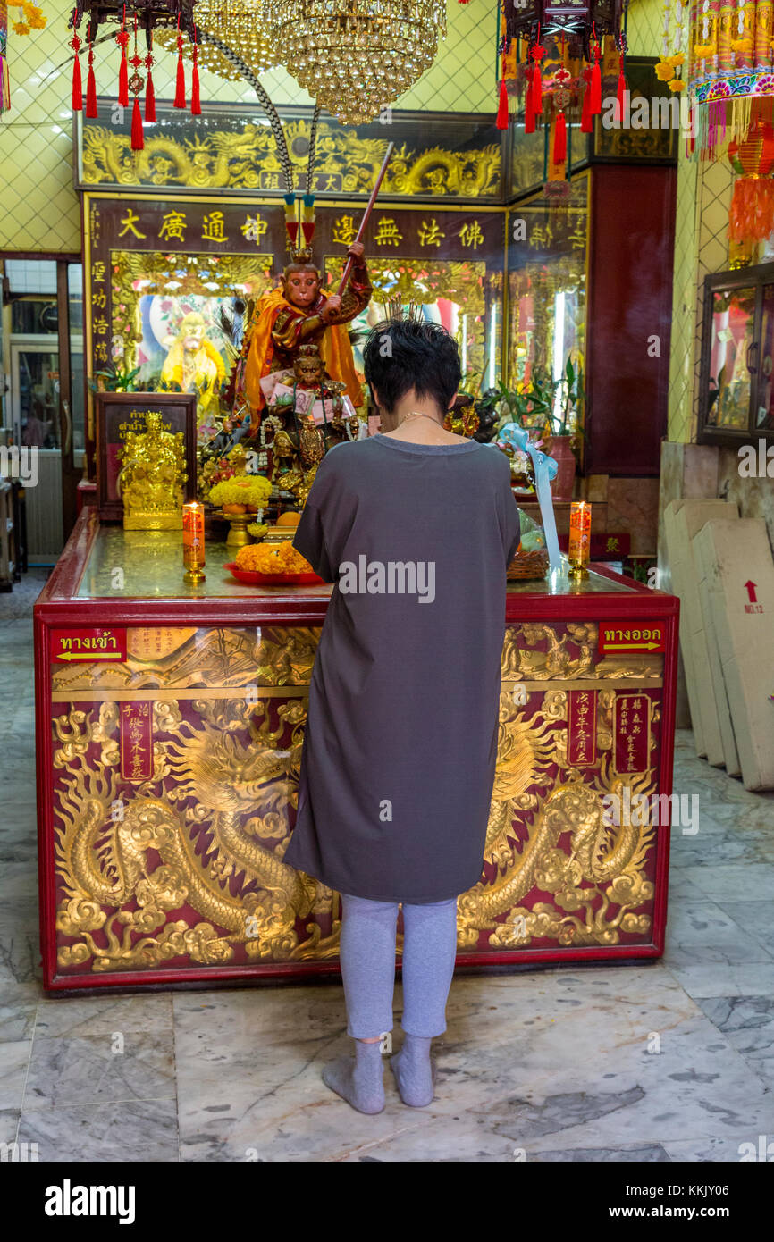 Bangkok, Thailand.  Woman Praying at Monkey King Shrine, Chinatown. Stock Photo