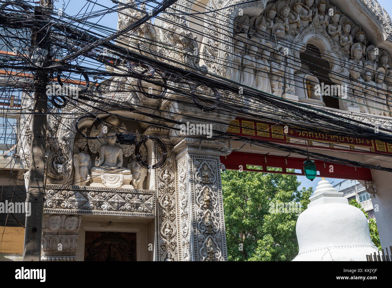Bangkok, Thailand.  Electric Power Lines in front of a Buddhist Shrine in Chinatown. Stock Photo