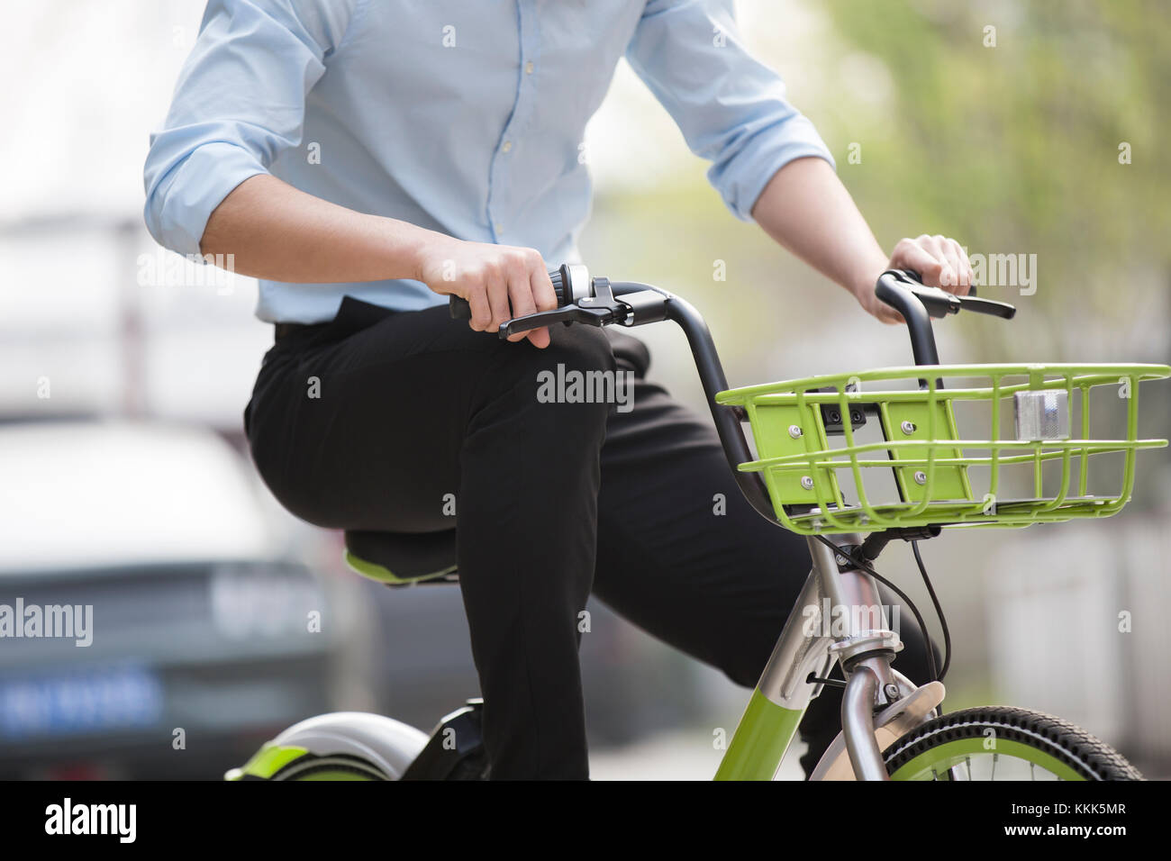 Young Chinese man riding a share bike Stock Photo