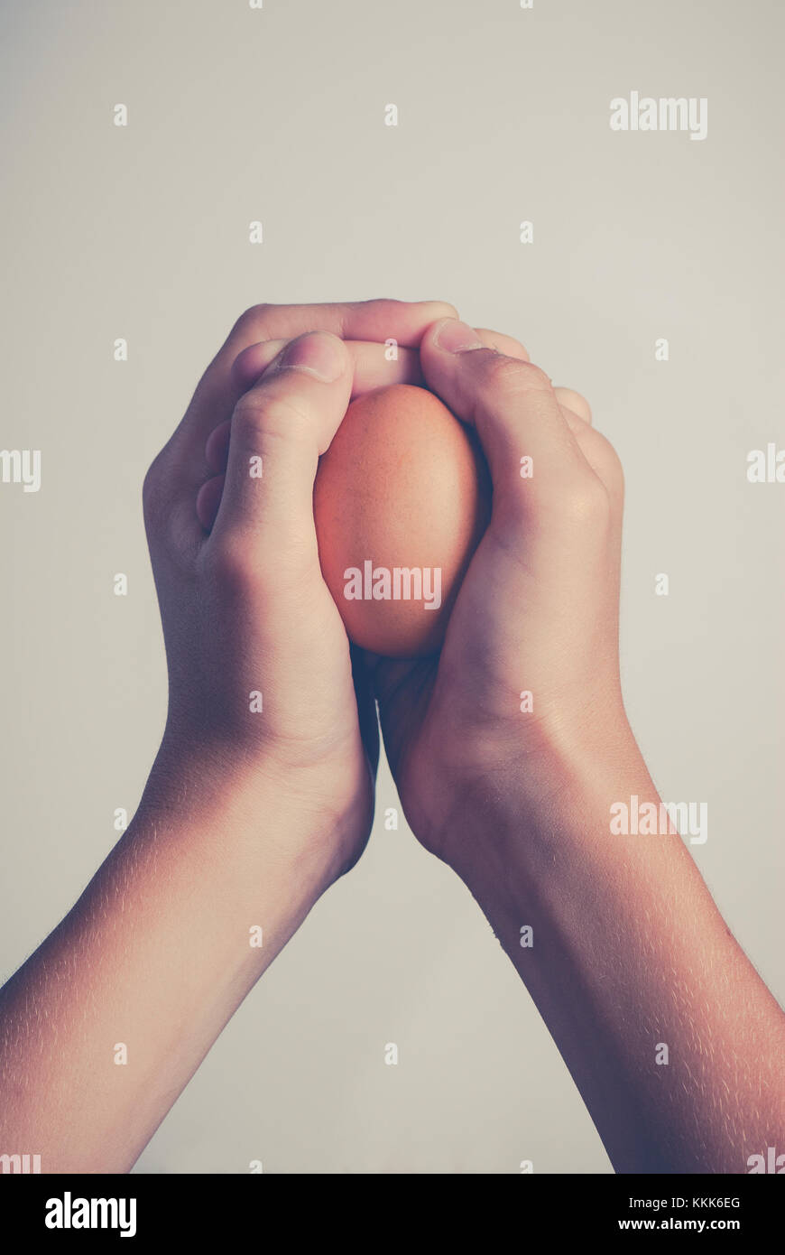 egg in human hands - protection concept Stock Photo