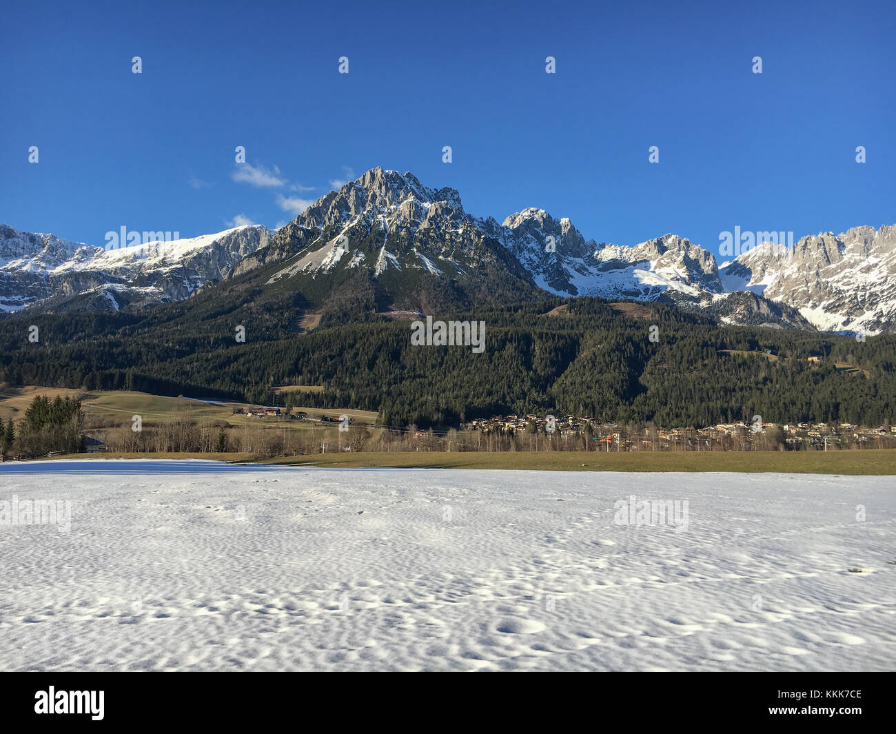 Ellmau and beautiful mountain range (Kaiser Mountains) in front of a blue sky at Wilder Kaiser region in Tyrol, Austria Stock Photo