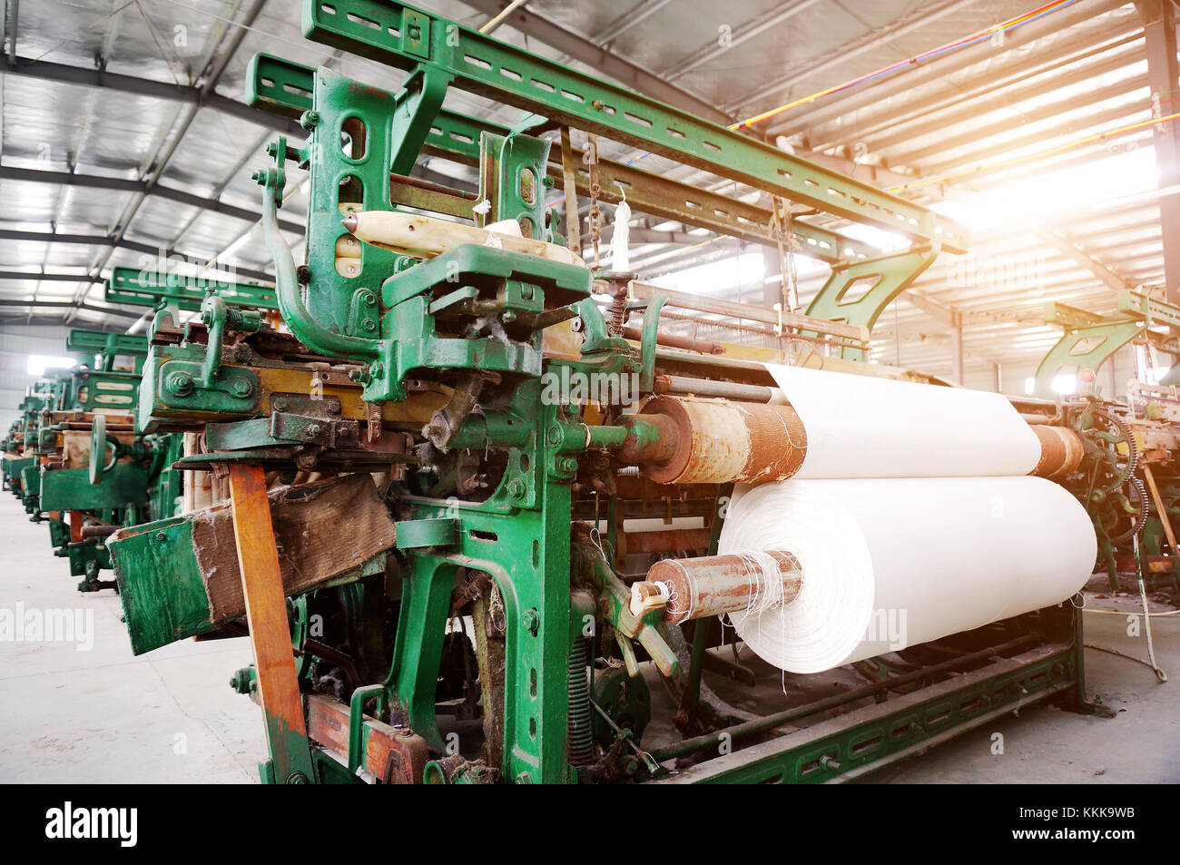 Old-fashioned loom, arranged in the factory workshop. Stock Photo