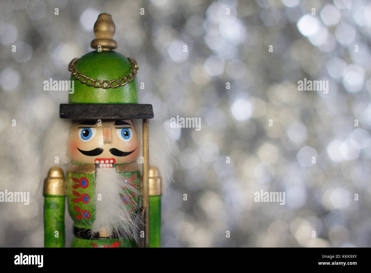Traditional Festive Nutcracker against a silver bokeh backdrop