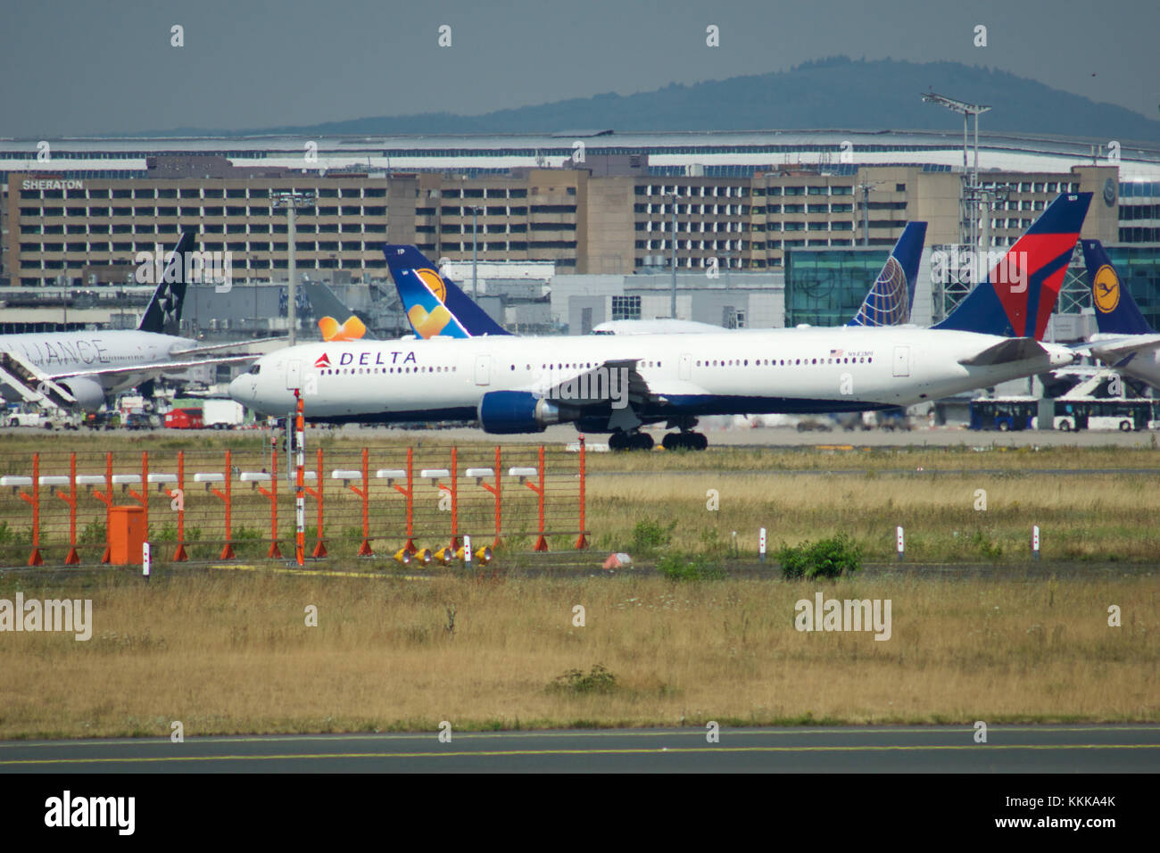 FRANKFURT, GERMANY - JUL 09th, 2017: Gate and terminal buildings at the Frankfurt Airport with varios airplanes in front and an Delta Airlines Jet ready for takeoff Stock Photo