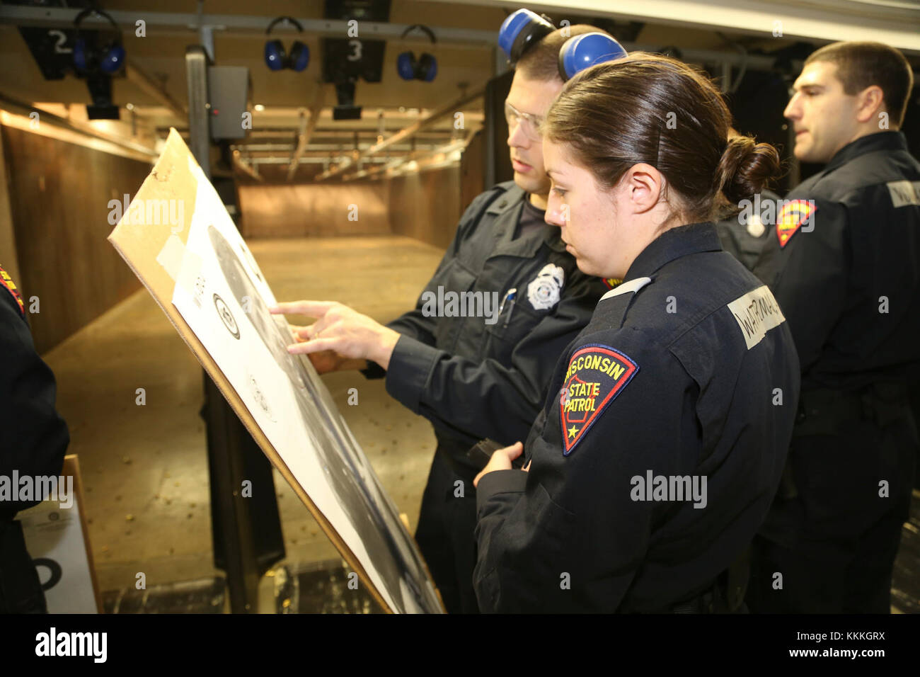 An instructor goes over a cadet's target with the cadet at the ...