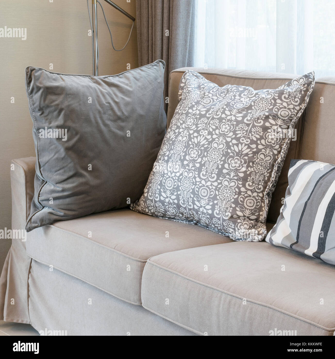 living room with brown sofa and grey patterned pillows Stock Photo - Alamy