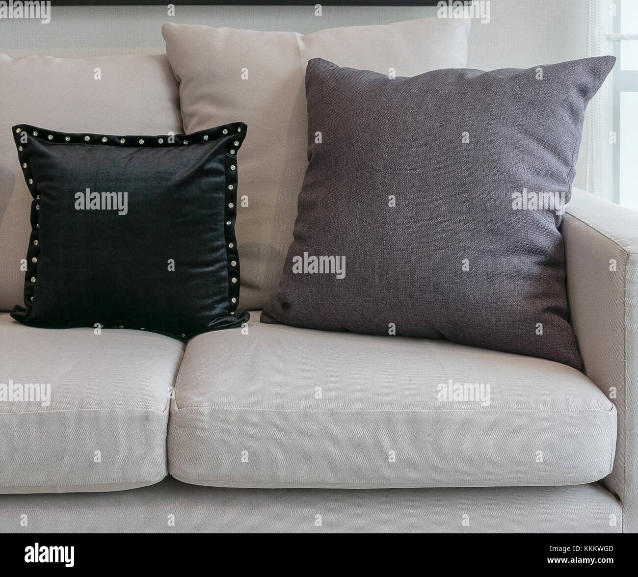 white sofa with black and grey pillows in living room interior Stock