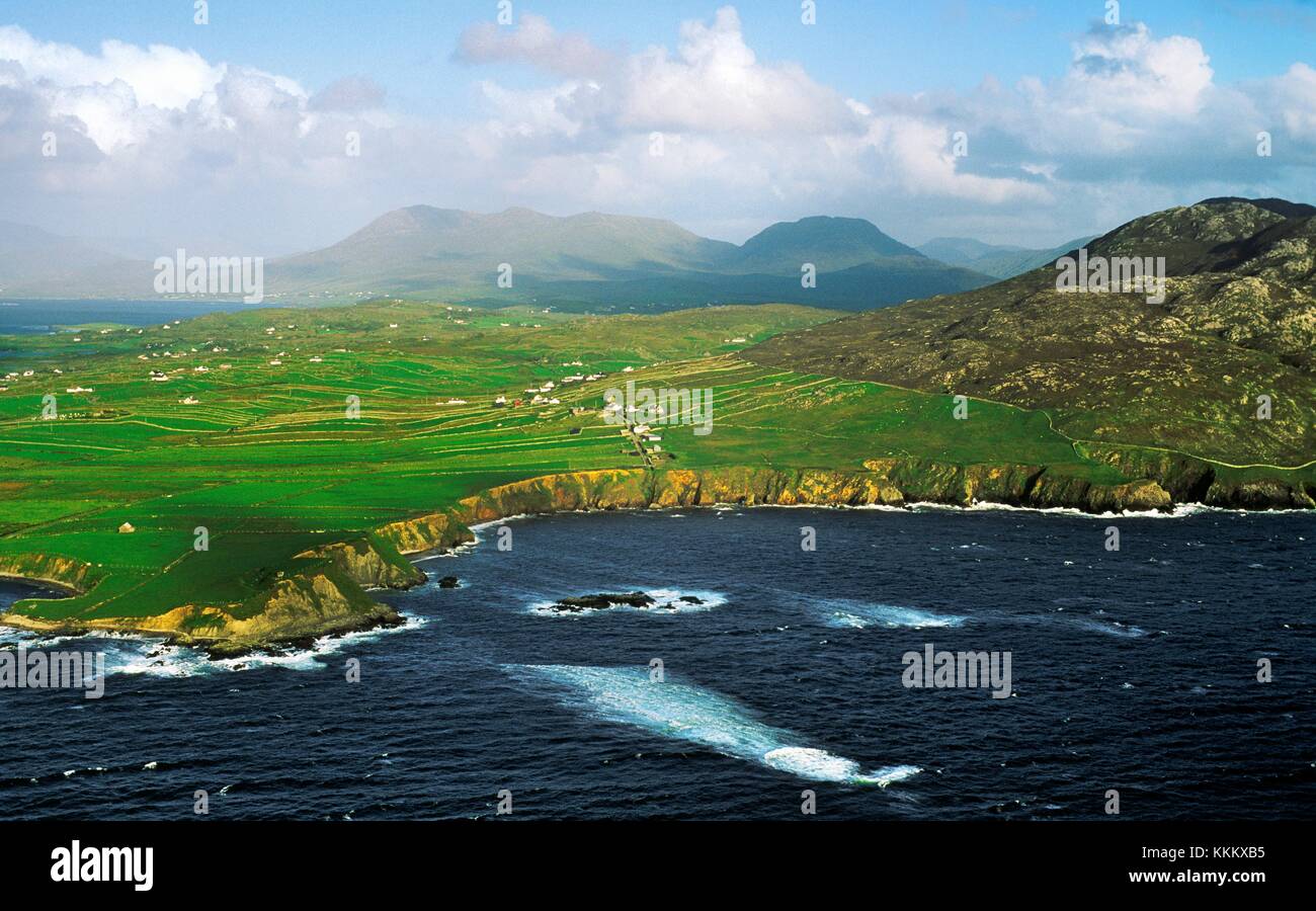 Northwest coast of County Galway, Ireland. Looking East across village of Tonadooravaun below Tully mountain to Mweelrea, Mayo Stock Photo