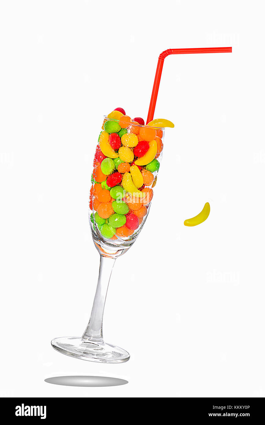 frozen glass full of candy falling over a white background Stock Photo