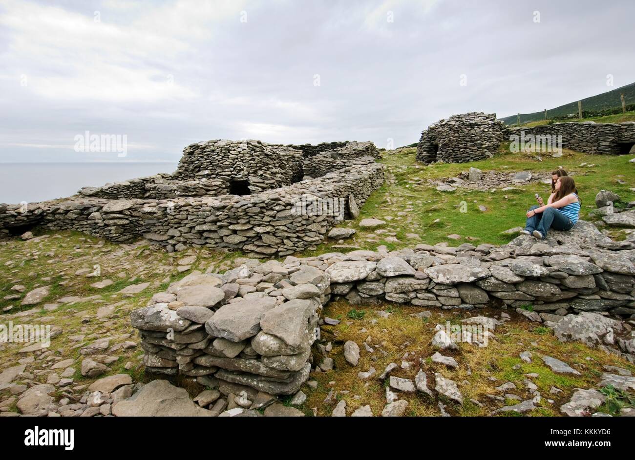 Ancient Celtic stone houses in walled enclosure settlement or cashel of Caher Conor east of Slea Head Stock Photo