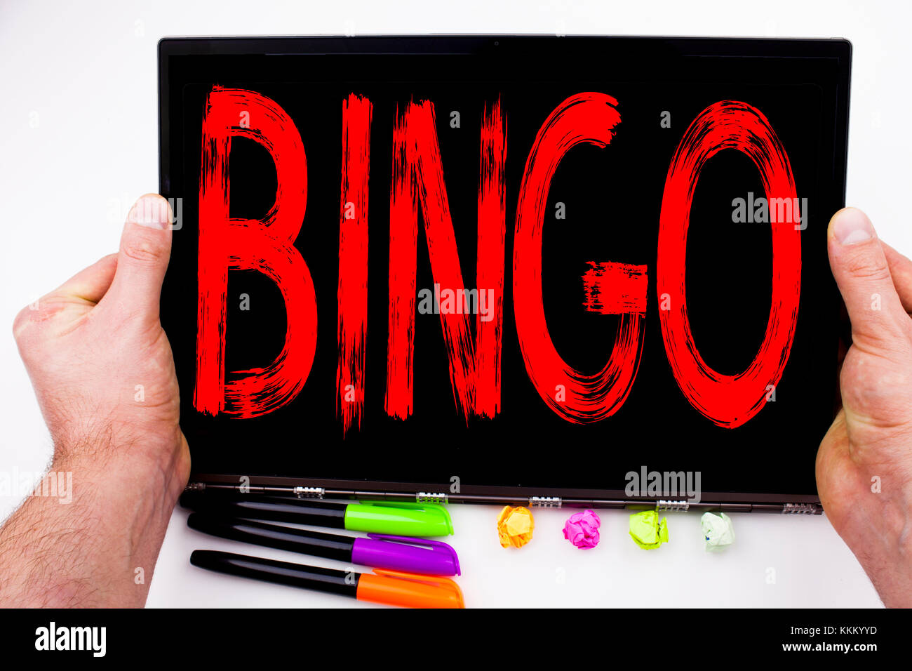 Bingo text written on tablet, computer in the office with marker, pen, stationery. Business concept for Lettering Gambling to Win Price Success white  Stock Photo