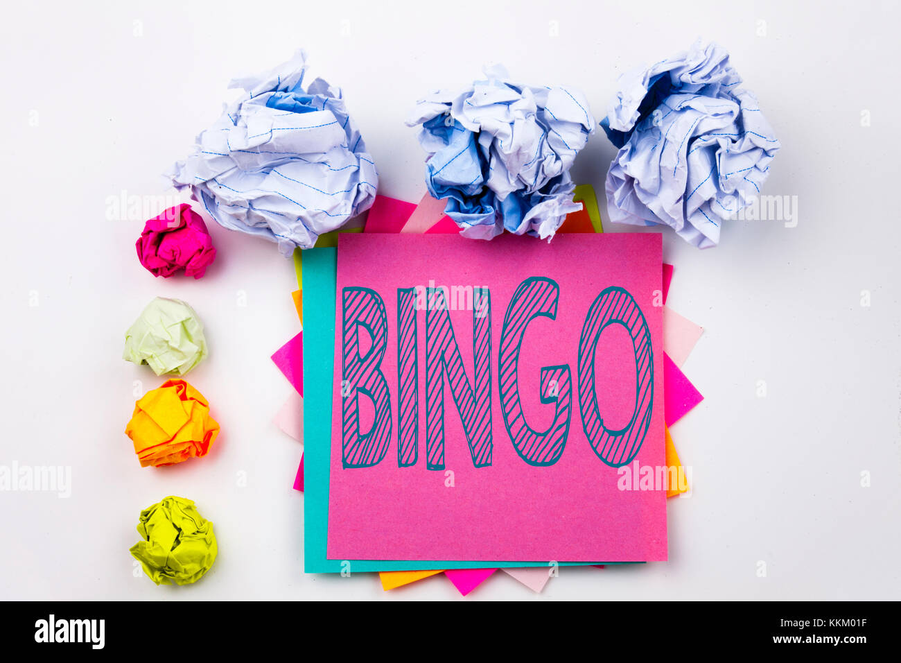 Writing text showing Bingo written on sticky note in office with screw paper balls. Business concept for Lettering Gambling to Win Price Success on wh Stock Photo
