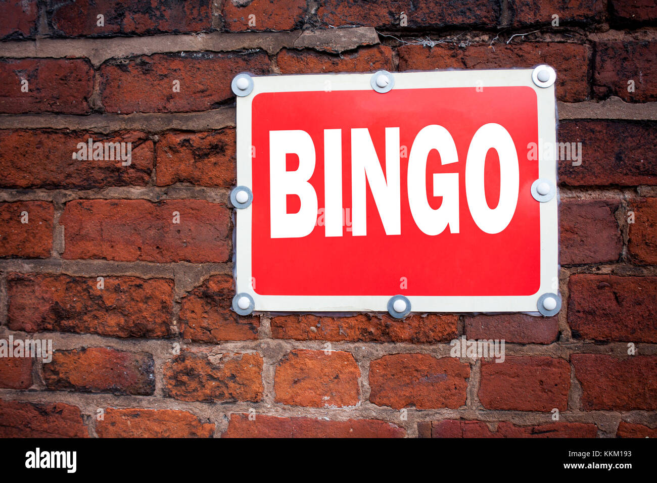 Hand writing text caption inspiration showing Bingo concept meaning Lettering Gambling to Win Price Success written on old announcement road sign with Stock Photo