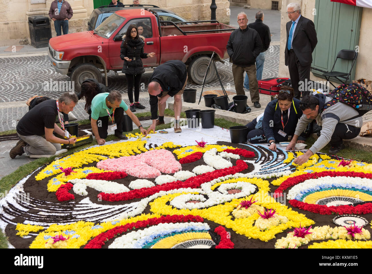 People making artistict street decorations using flower petals in a festival in Gozo Malta Stock Photo