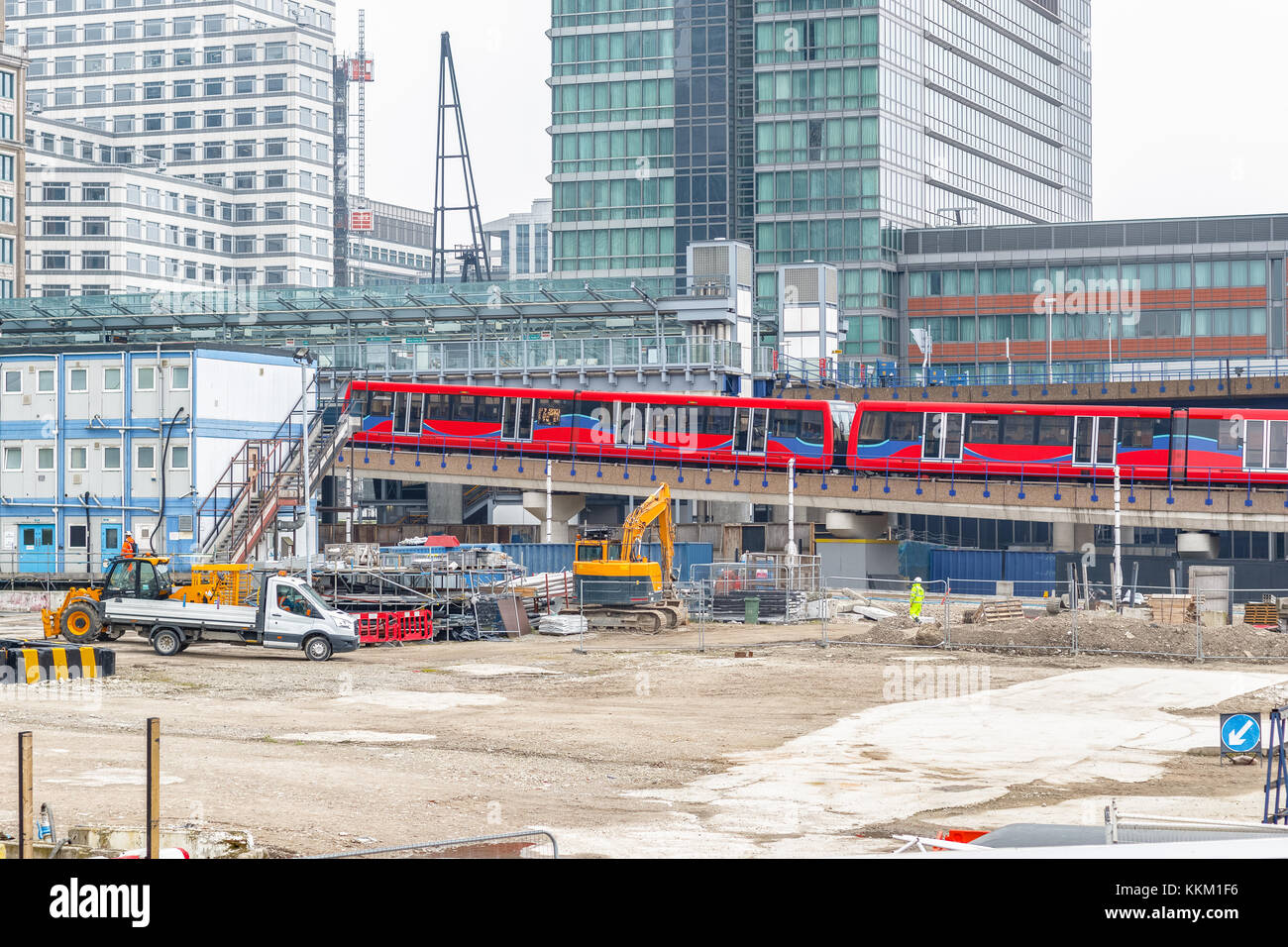 Construction site in Canary Wharf in London with trains arriving station Stock Photo