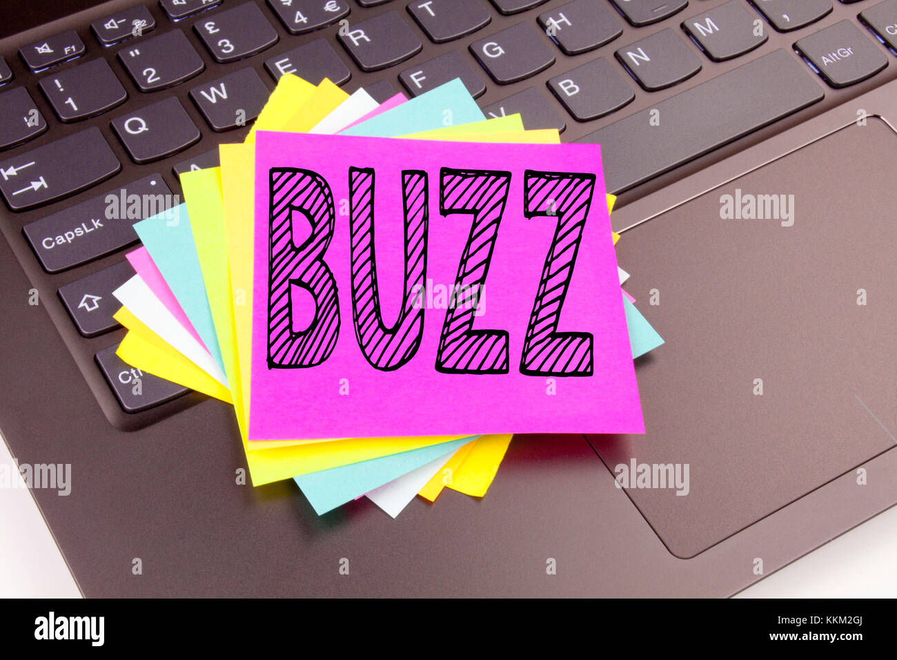 Writing Buzz text made in the office close-up on laptop computer keyboard. Business concept for Buzz Word llustration Workshop on the black background Stock Photo