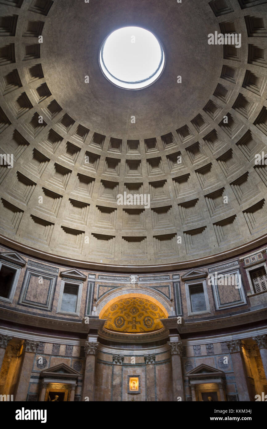 Inside the Pantheon in Rome, Italy looking up at the oculus (hole) in the ceiling and it's geometric dome design. Stock Photo