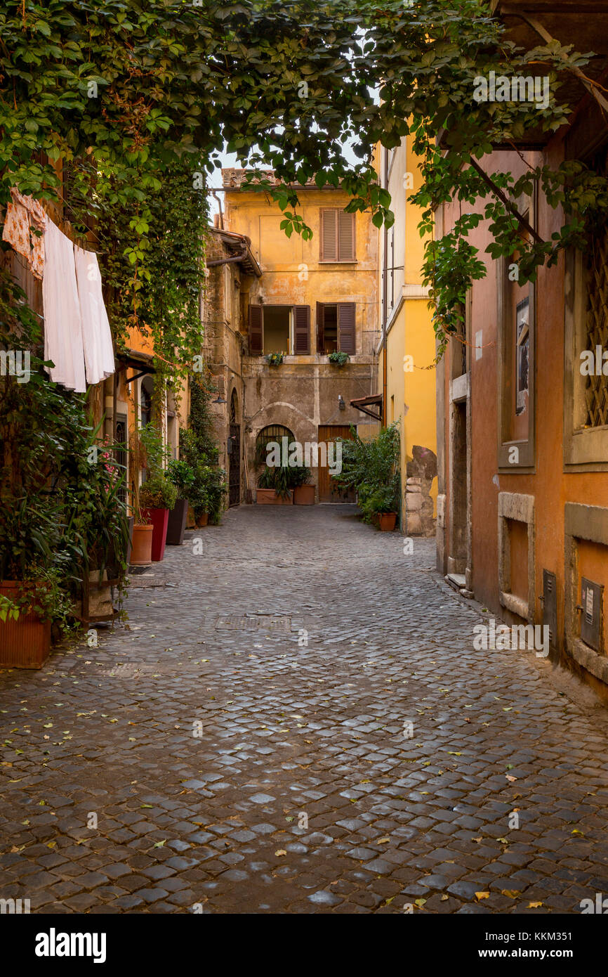 A cobbled back street in the Trastevere area of Rome, Italy with washing hanging outside one of the buildings. Stock Photo