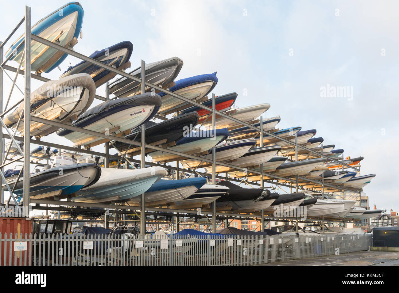 A rack of boats pointing diagonally before a pale blue sky Stock Photo ...