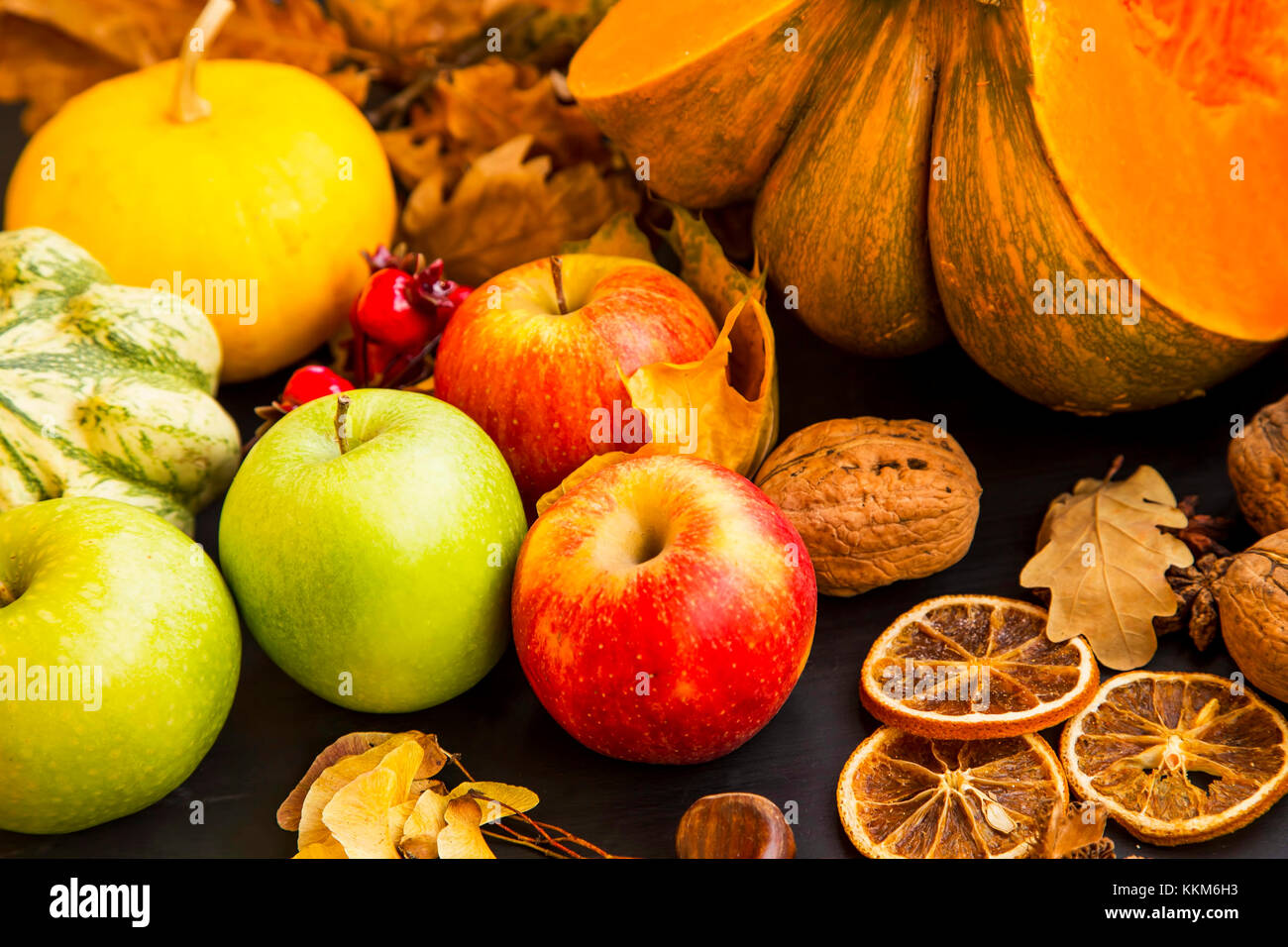 Autumn apples, fall fruits harvesting with pumpkins ,nuts and spices Stock Photo
