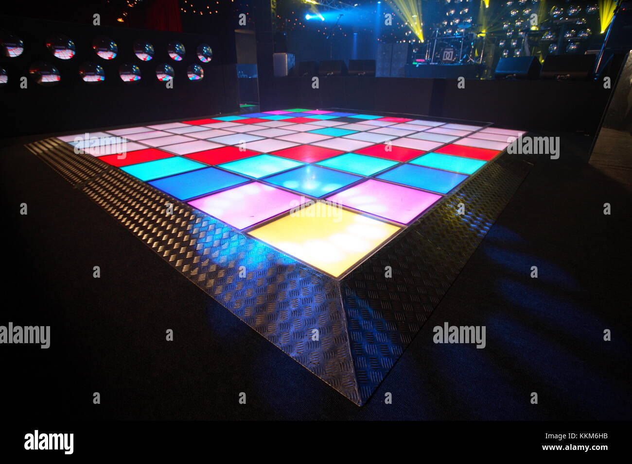 An empty dance floor with illuminated disco squares.  ready for a dance party and celebration.  Seventies kitsch style. Event Stock Photo