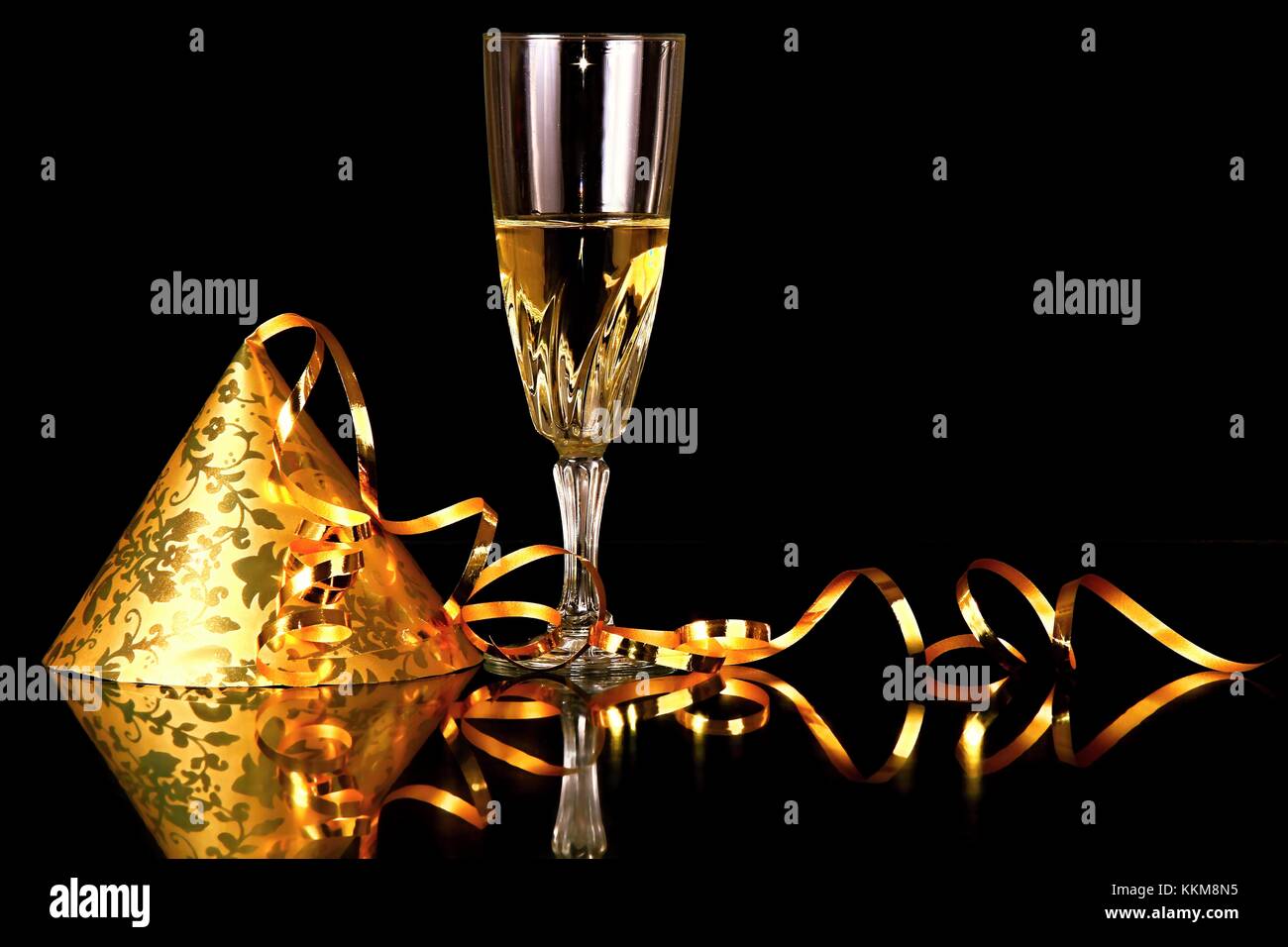 Image of New years eve celebration with hat and glass of champagne on a ...