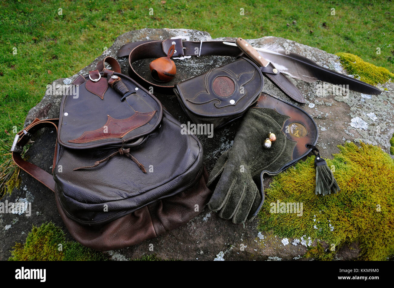 Falconer's equipment on a moss-covered stone arranges Stock Photo