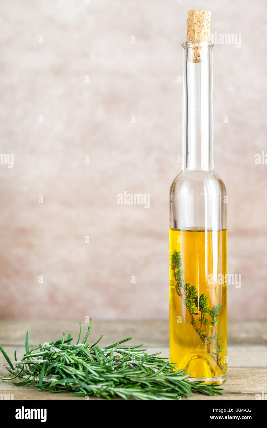 Bottle with olive oil on the old-fashioned background Stock Photo - Alamy