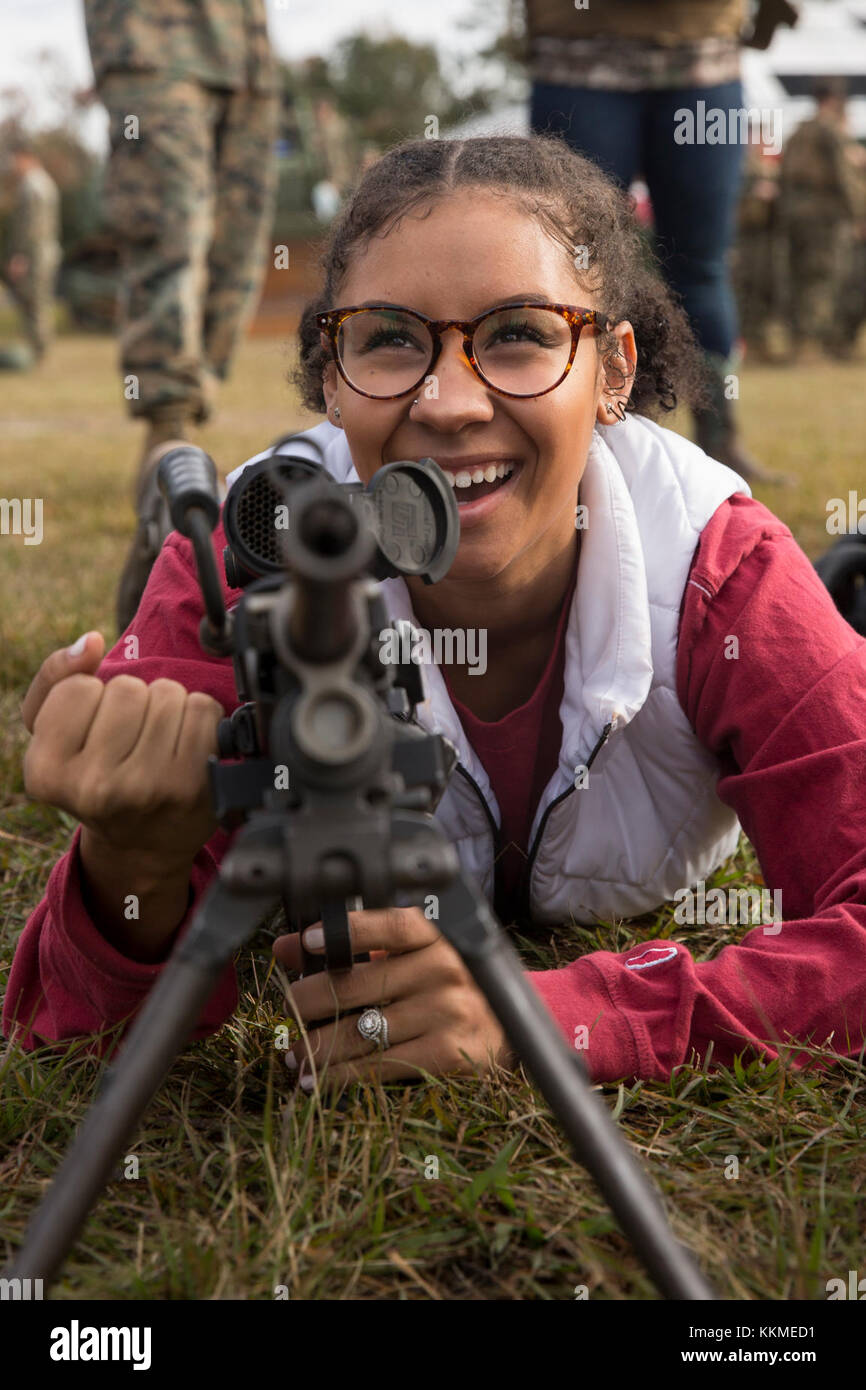 A military spouse performs a functions check on a M240 machine gun