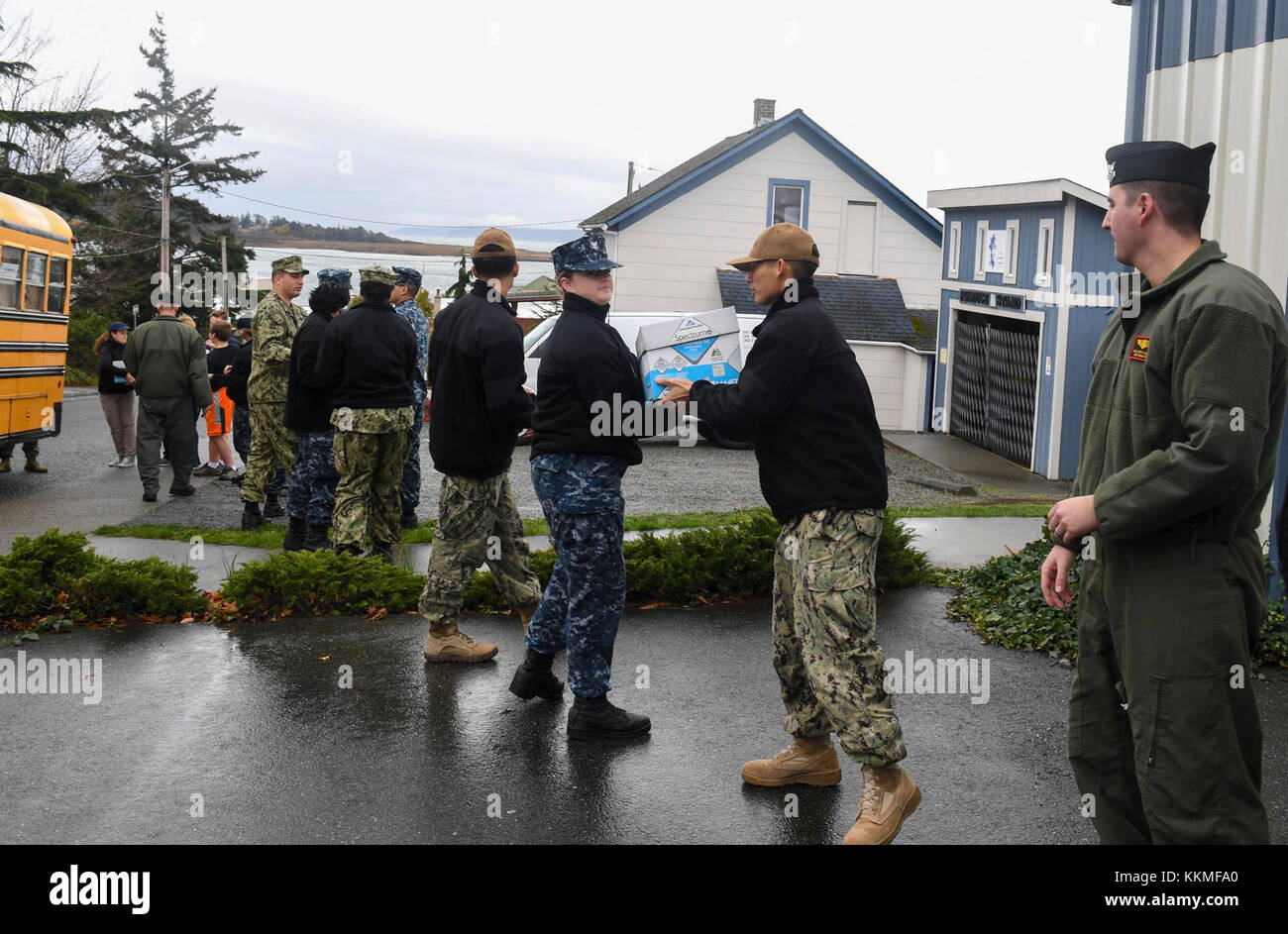 OAK HARBOR, Wash. (November 21, 2017) Sailors stationed at Naval Air Station Whidbey Island unload food from local Whidbey Island school buses at the North Whidbey Help House on Whidbey Island as part of the Un-Stuff the Bus charity event. The event afforded Sailors the opportunity to support the local community by 'un-stuffing' busses that local schools filled full of food for the North Whidbey Help House to hand out to families in need for Thanksgiving.  (U.S. Navy photo by Mass Communication Specialist 2nd Class Scott Wood/Released) Stock Photo