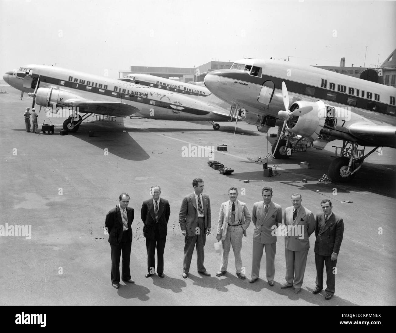 In August 1941, Douglas Aircraft Company personnel posed with three Hawaiian Airlines Douglas DC-3 aircraft—'Haleakala' (fleet no. 7), 'Waialeale' (fleet no. 8), and 'Mauna Loa' (registration N33606)—at the Santa Monica, California, plant before their delivery flights from Oakland Field, California, to John Rodgers Airport, Honolulu, Hawaii. Stock Photo