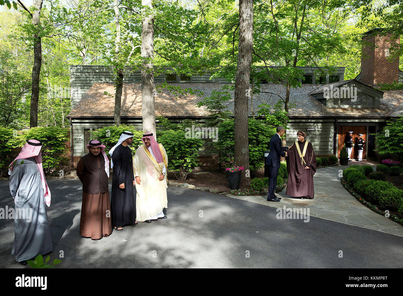 May 14, 2015 'The President had hosted a summit meeting at Camp David with the Gulf Cooperation Council. At the conclusion of the summit, each of the leaders was introduced before a final group photo in front of Laurel Cabin. Rather than shoot a tight shot of each leader, I used a wide angle lens to show more of the atmosphere of Camp David. Here, the President greets Sayyid Fahd bin Mahmoud al Said, Deputy Prime Minister for the Council of Ministers’ Affairs of the Sultanate of Oman.' (Official White House Photo by Pete Souza) This official White House photograph is being made available only  Stock Photo