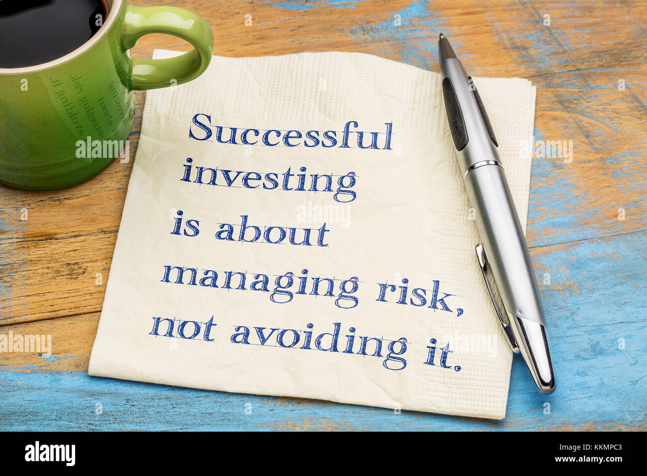 Successful investing is about managing risk, not avoiding it - handwriting on a napkin with a cup of coffee Stock Photo