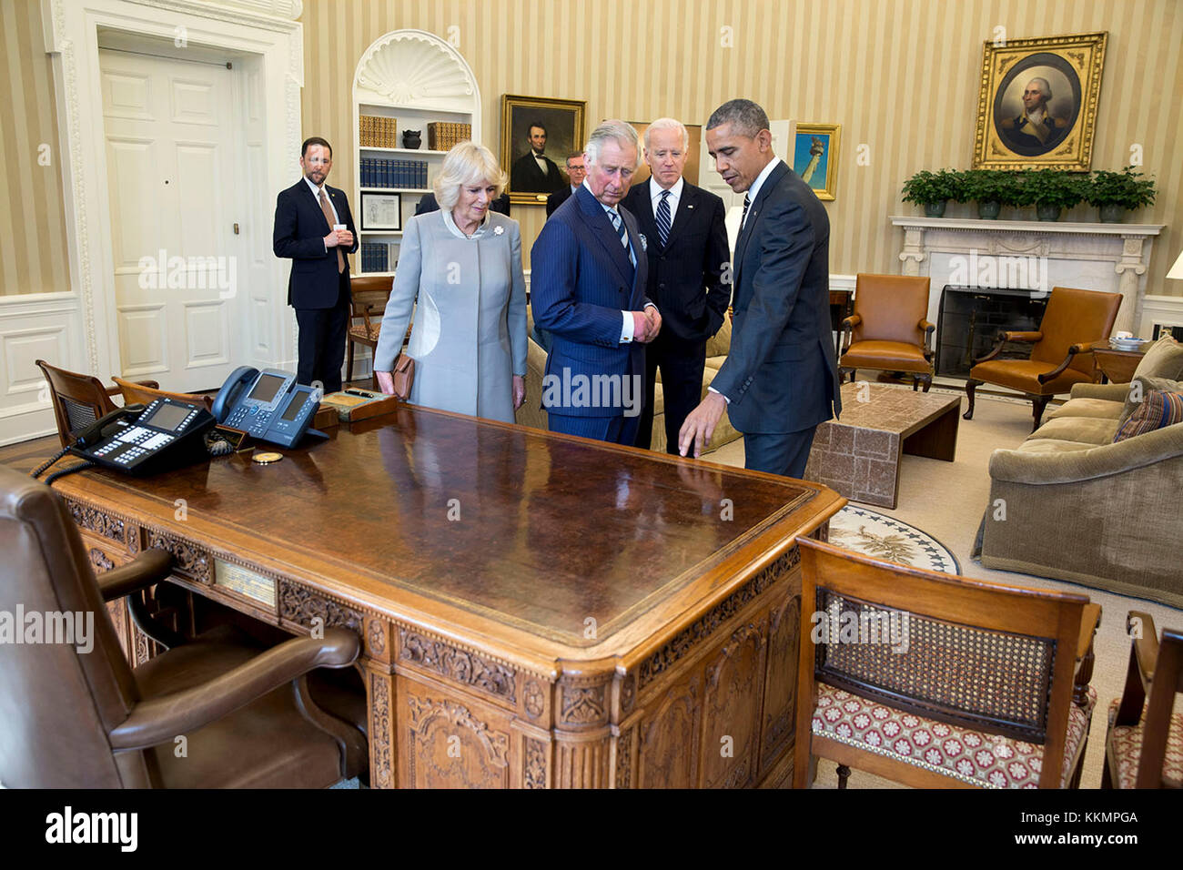 President Barack Obama and Vice President Joe Biden discuss the Resolute  Desk with Charles, Prince of Wales and Camilla, Duchess of Cornwall, prior  to a meeting in the Oval Office, March 19,