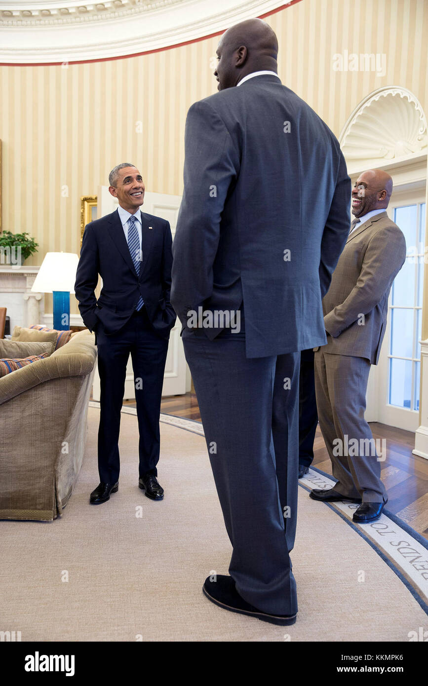 Feb. 27, 2015 'It's definitely true that former NBA player Shaquille O'Neal is a big guy. But I'll admit that I used a wide angle lens and this angle to accentuate his size when he stopped by the Oval Office for a quick visit.' (Official White House Photo by Pete Souza) This official White House photograph is being made available only for publication by news organizations and/or for personal use printing by the subject(s) of the photograph. The photograph may not be manipulated in any way and may not be used in commercial or political materials, advertisements, emails, products, promotions tha Stock Photo