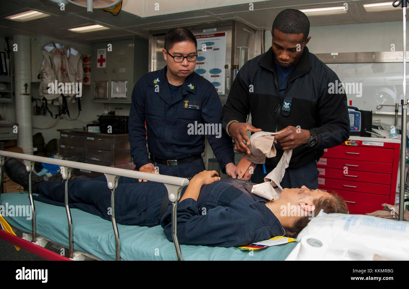 171124-N-VK310-0047 ATLANTIC OCEAN (Nov. 24, 2017) Sailors assigned to the medical department aboard the amphibious assault ship USS Wasp (LHD 1) assess a simulated patient during a mass casualty drill. Wasp is transiting to Sasebo, Japan to conduct a turnover with the USS Bonhomme Richard (LHD 6) as the forward-deployed flag ship of the amphibious forces in the U.S. 7th Fleet area of operations. (U.S. Navy photo by Mass Communication Specialist 3rd Class Michael Molina/Released) Stock Photo