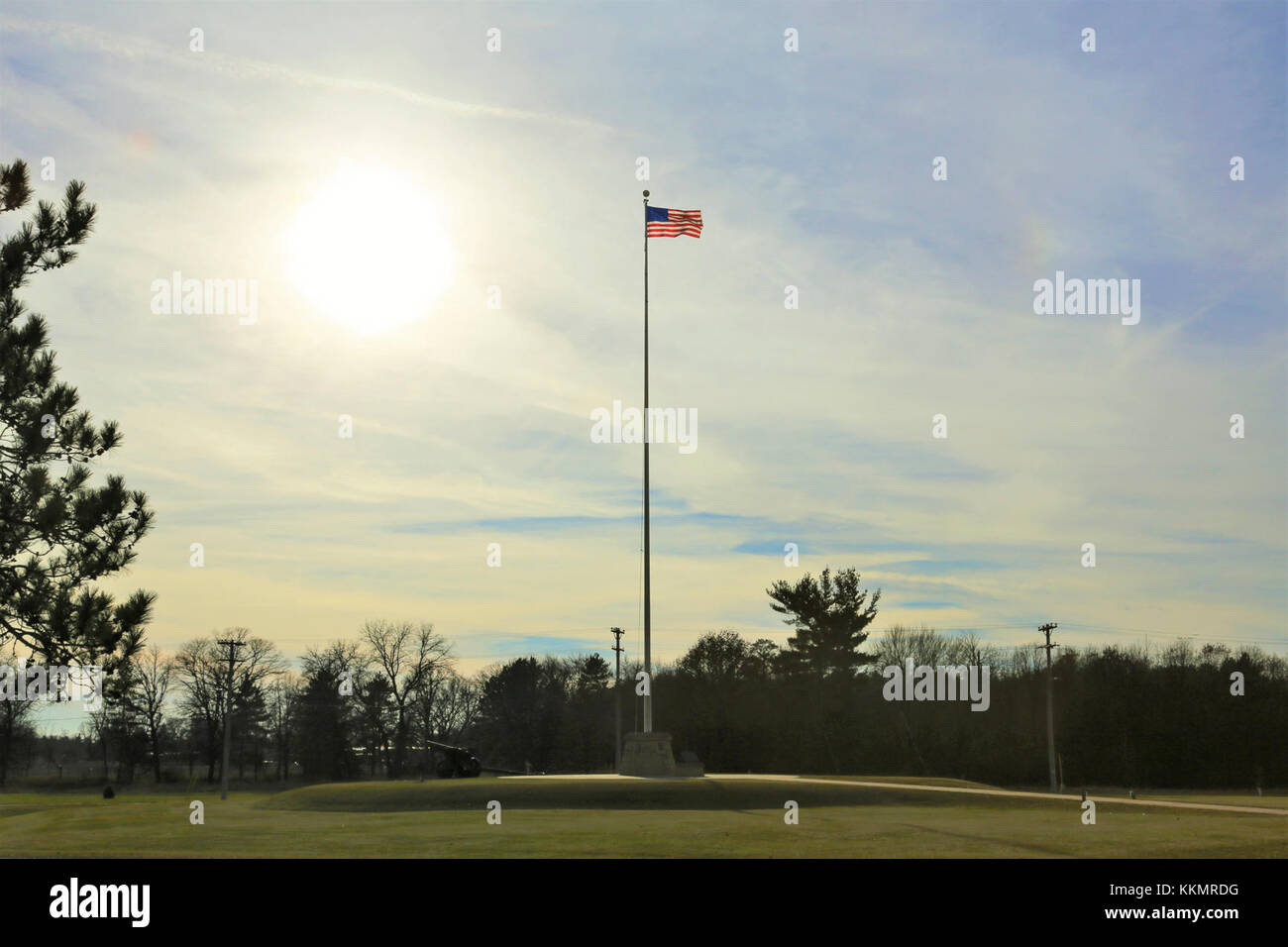 The flag of the United States of America is brightened by a backdrop of afternoon sun Nov. 27, 2017, while flying on the flagpole in front of Garrison Headquarters at Fort McCoy, Wis. The weather for late November was unseasonably warm with temperatures around 50 degrees Fahrenheit. (U.S. Army Photo by Scott T. Sturkol, Public Affairs Office, Fort McCoy, Wis.) Stock Photo
